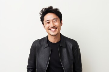 Obraz premium Lifestyle portrait of a Chinese man in his 30s in a white background wearing a chic cardigan