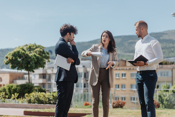 Businesswoman standing and leading project. Businesswoman holding paperwork explaining something to...