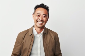 Medium shot portrait of a Chinese man in his 40s in a white background wearing a chic cardigan