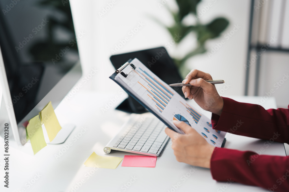 Poster hands of a businessman who are working on paperwork while sitting on a desk.