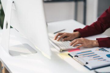 Hands of businessman working on keyboard keyboard searching work document on computer screen.