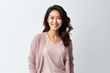 Fototapeta premium Portrait of a smiling young asian woman standing over white background