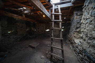 A staircase between floors inside. the foot of the mountains of the watchtowe. Interior Tower of Love in Svaneti in the mountains part of Georgia