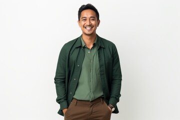 Fototapeta premium Young indian man with green shirt smiling and looking to the side