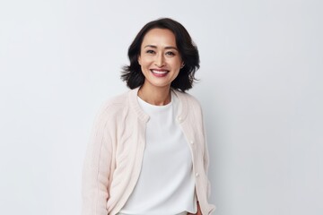 Medium shot portrait of a Indonesian woman in her 40s in a white background wearing a chic cardigan