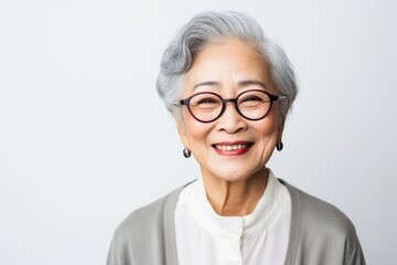 Fototapeta premium Asian senior woman wearing eyeglasses with smile on white background.