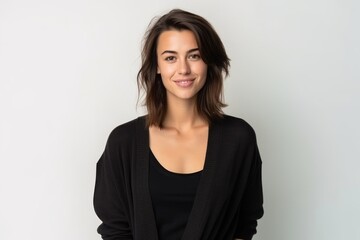Fototapeta premium Medium shot portrait of a Russian woman in her 30s in a white background wearing a chic cardigan