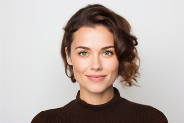 Fototapeta premium Close-up portrait of a Russian woman in her 30s in a white background wearing a chic cardigan