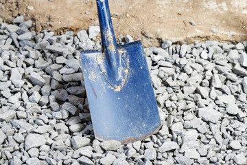 Shovel on the background of stones during the construction of the house.
