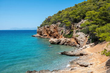 Greece, Dragonera beach in Agistri Island at Saronic Gulf. Pine tree, crystal sea, blue sky.