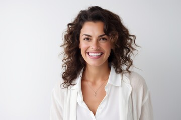 Lifestyle portrait of a Brazilian woman in her 30s in a white background wearing a chic cardigan