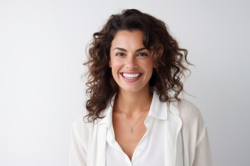 Fototapeta premium Lifestyle portrait of a Brazilian woman in her 30s in a white background wearing a chic cardigan