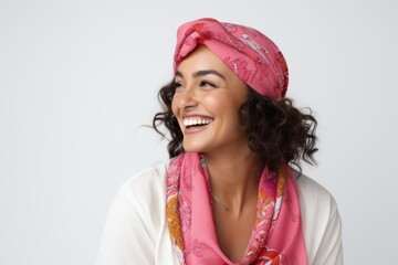 Lifestyle portrait of a Brazilian woman in her 30s in a white background wearing a foulard