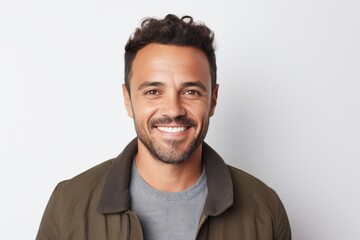 Fototapeta premium Portrait of a handsome man smiling at the camera over white background