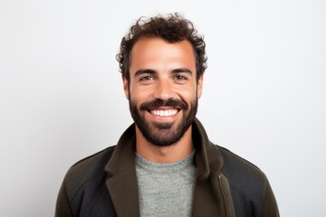 Obraz premium Portrait of a handsome young man smiling at the camera against white background