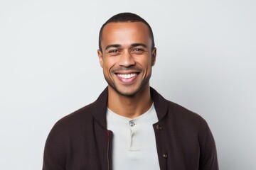 Portrait of happy young african american man smiling against white background