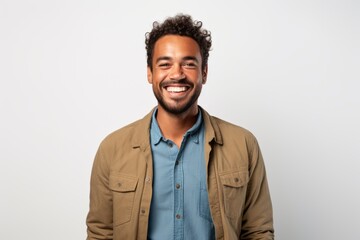 Fototapeta premium Lifestyle portrait of a Brazilian man in his 30s in a white background wearing a chic cardigan