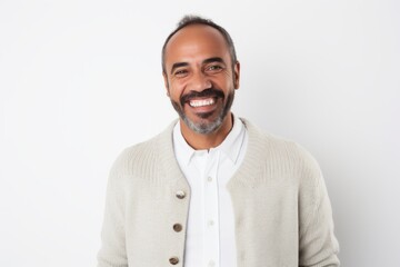 Medium shot portrait of a Brazilian man in his 40s in a white background wearing a chic cardigan