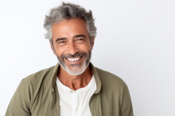 Portrait of handsome mature man in casual clothes looking at camera and smiling while standing against white background