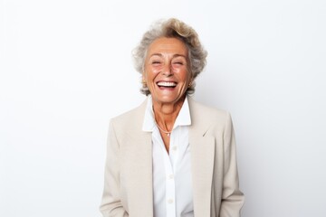 Portrait of a happy senior woman laughing at the camera on white background