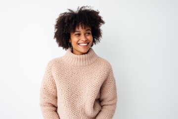 Medium shot portrait of a Nigerian woman in her 20s in a white background wearing a cozy sweater
