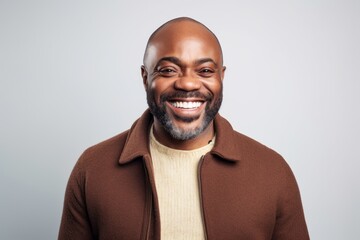 Obraz premium Medium shot portrait of a Nigerian man in his 40s in a white background wearing a chic cardigan
