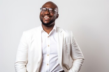Lifestyle portrait of a Nigerian man in his 40s in a white background wearing a chic cardigan
