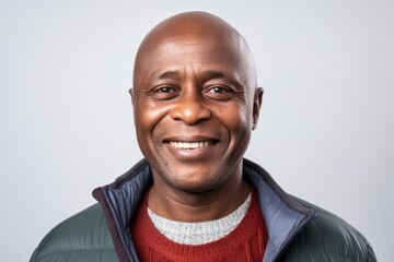 Obraz premium Portrait of a happy african american man smiling against white background