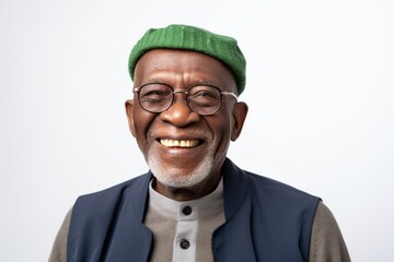 Group portrait of a Nigerian man in his 70s in a white background wearing a chic cardigan