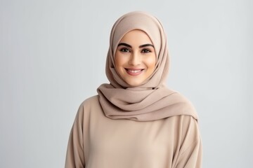 Portrait of beautiful muslim woman in hijab looking at camera and smiling