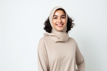 Fototapeta premium Portrait of a smiling muslim woman wearing hijab isolated on a white background