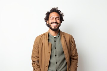Fototapeta premium Portrait of a smiling young latin man standing on white background