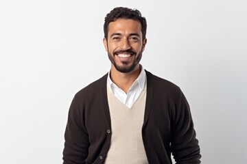 Portrait of handsome bearded Indian man in casual clothes smiling and looking at camera