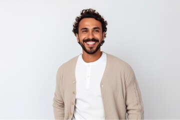 Fototapeta premium Portrait of young handsome man with curly hair looking at camera and smiling.