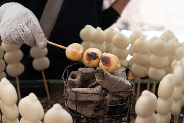 Mitarashi dango, street food in Japan, grilled on a barbecue