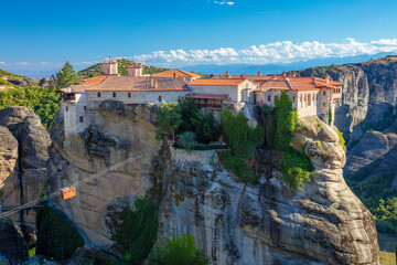 Fototapeta na wymiar Meteora monasteries, Greece. Panoramic view on the Holy Monastery of Varlaam placed on the edge of high rock. The Meteora area is on UNESCO World Heritage. Greece