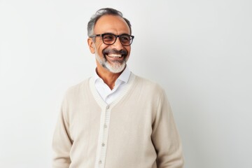 Portrait of smiling mature Indian man in eyeglasses looking at camera
