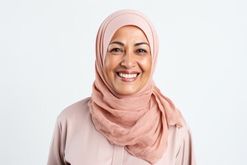 Portrait of happy muslim woman with hijab looking at camera over white background