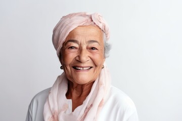 Portrait of senior asian woman wearing headscarf on white background