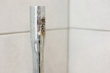 Dirty calcified shower chrome mixer tap, faucet with limescale on it, plaque from hard water. Steel...