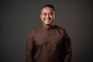 Fototapeta premium Portrait of a smiling asian muslim man wearing traditional clothing