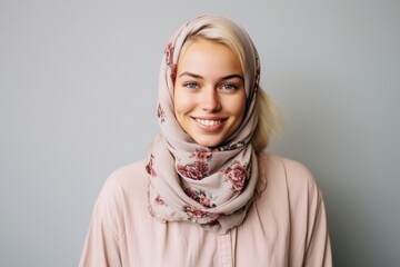 Portrait of a happy young muslim woman in hijab looking at camera