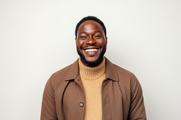 Fototapeta premium Portrait of a happy african american man laughing against white background