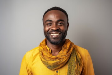 Fototapeta premium Portrait of a happy young african american man wearing yellow scarf