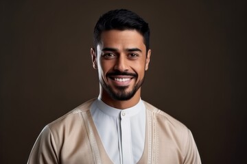 Fototapeta premium Portrait of a young muslim man smiling and looking at camera