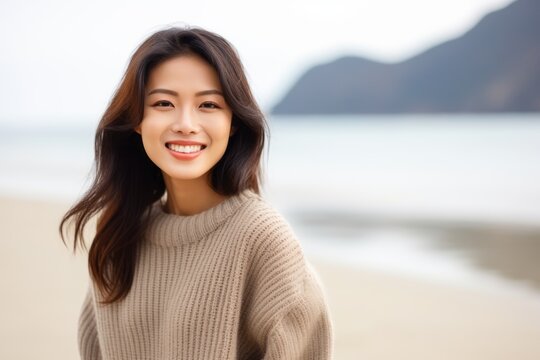Portrait of beautiful young asian woman smiling on the beach.