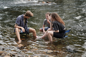 Group of smiling friends hiking with backpacks outdoors. Travel, tourism, hike and people concept