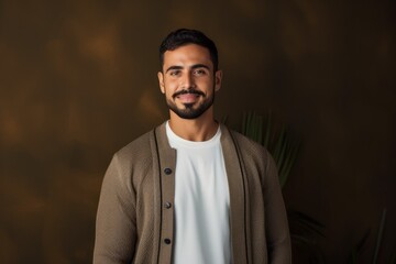 Obraz premium portrait of handsome bearded indian man looking at camera and smiling