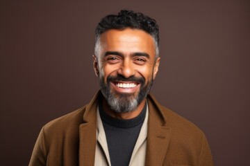 Obraz premium Portrait of a smiling Indian man with a beard wearing a coat