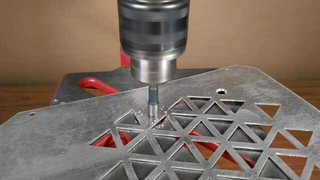 Countersinking of aluminum with a drilling machine. The concept of electrical repair equipment. Taken close-up from above. High quality 4k footage